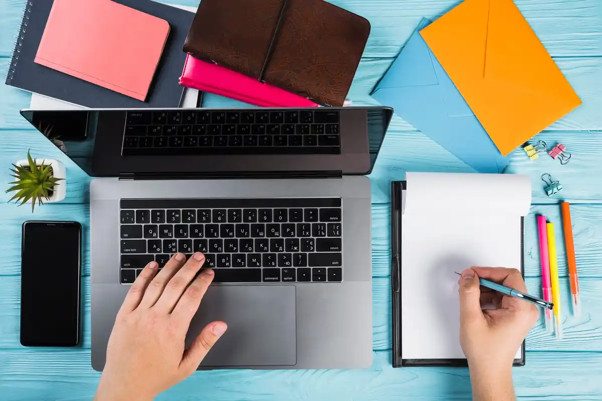 creative left handed person using notebook
