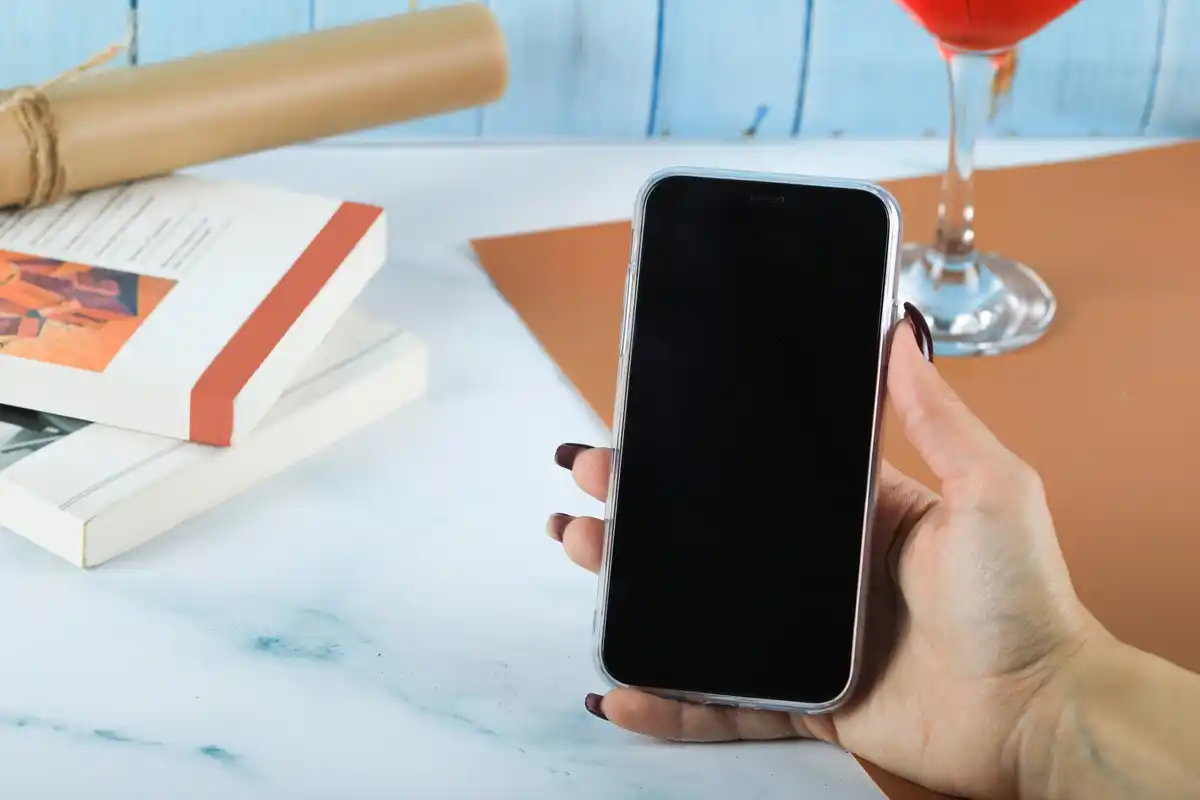 old smartphone on table with NASA logo in background