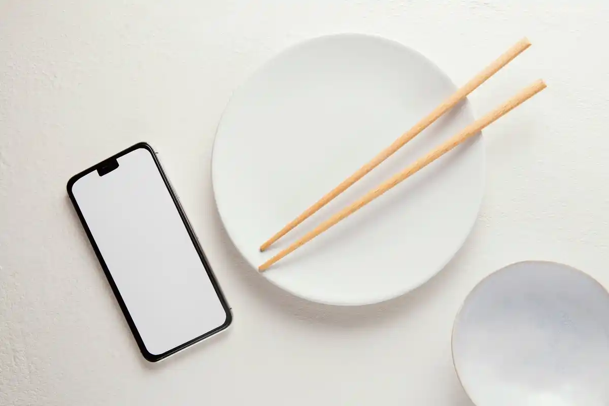 wet smartphone in rice on the table, top view