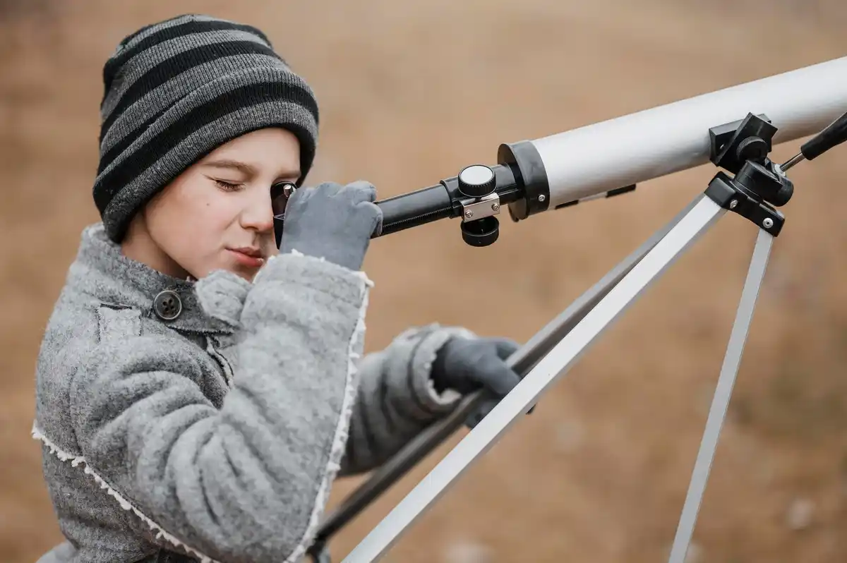 dutch children looking at the moon with telescope