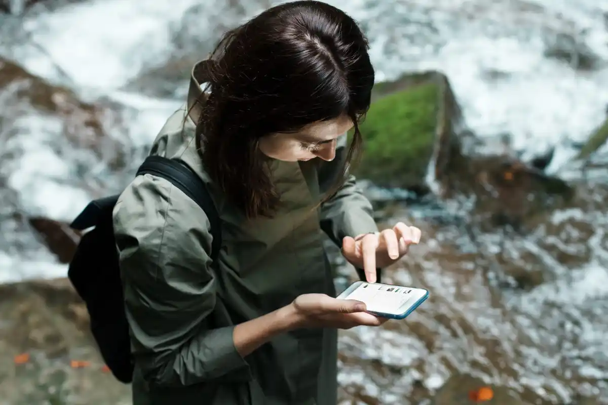archeologist writing notes in muddy field notebook