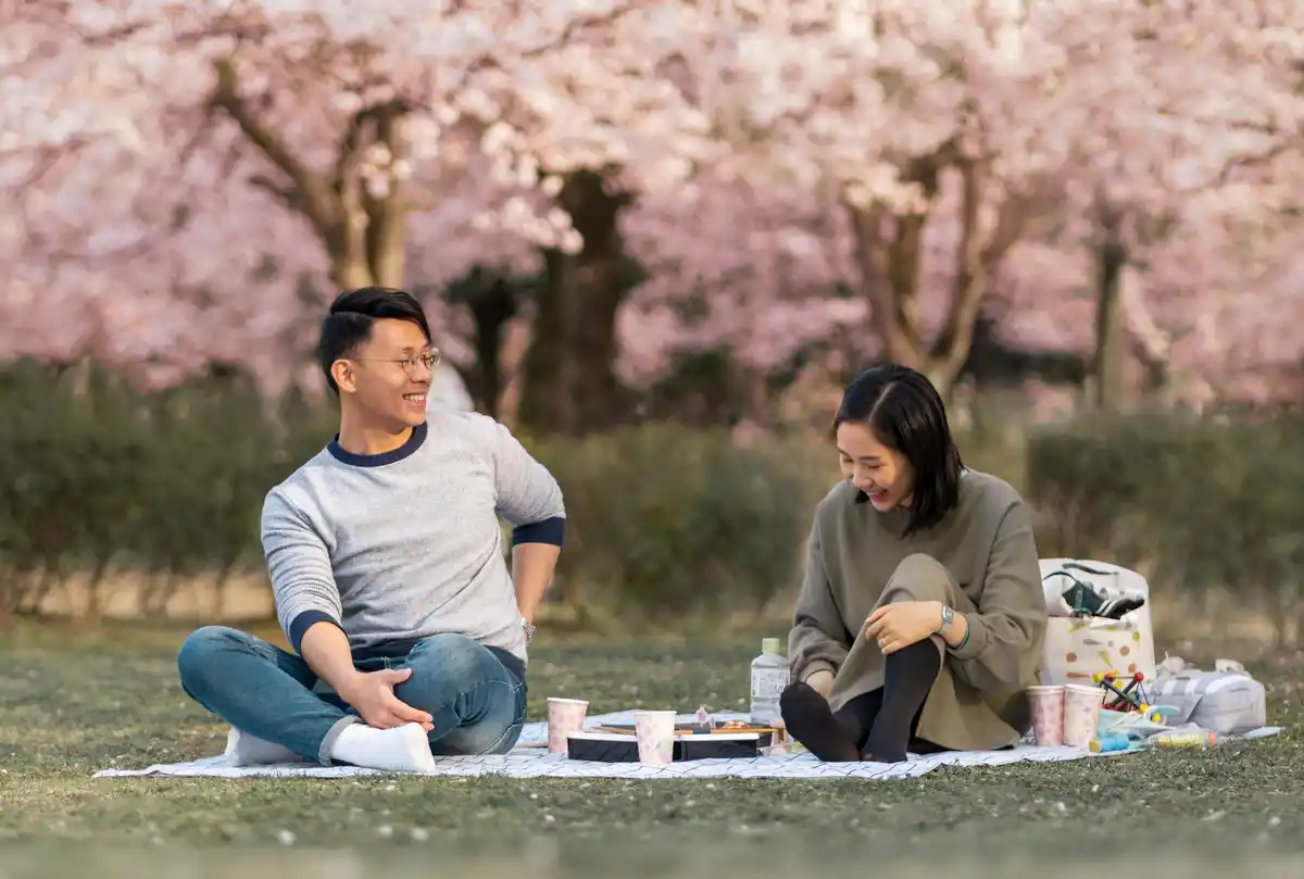 Japanese people eating food in park sitting still