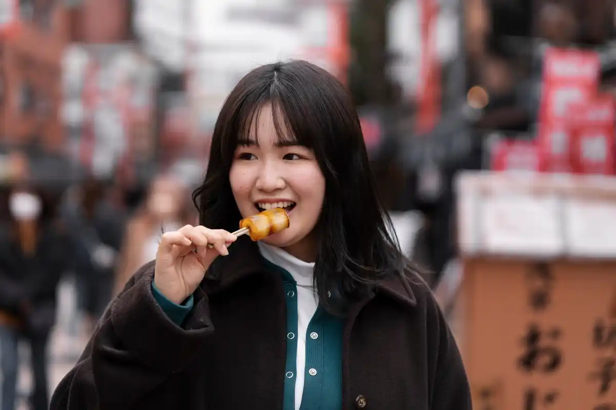 Japanese people eating street food sitting down