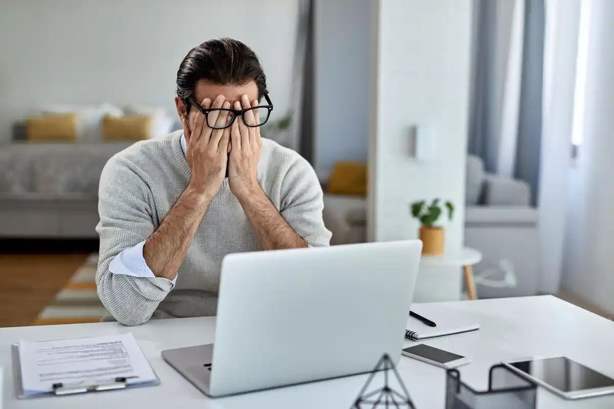 dutch man frustrated slow laptop home office
