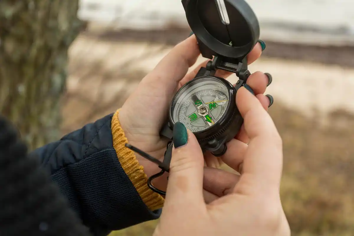 man using a compass in dutch national park