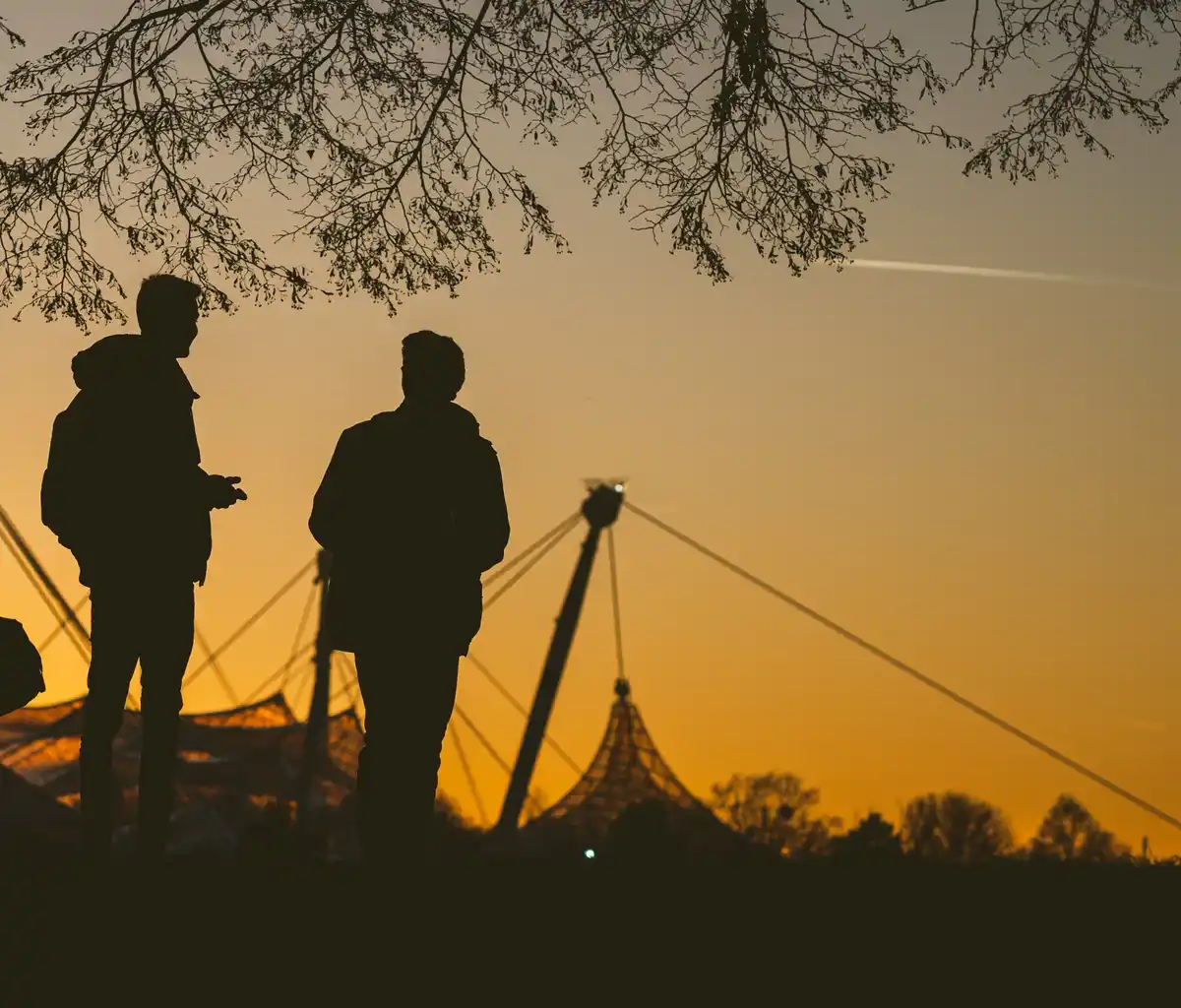 group of Dutch amateur archeologists metal detecting field with windmill background