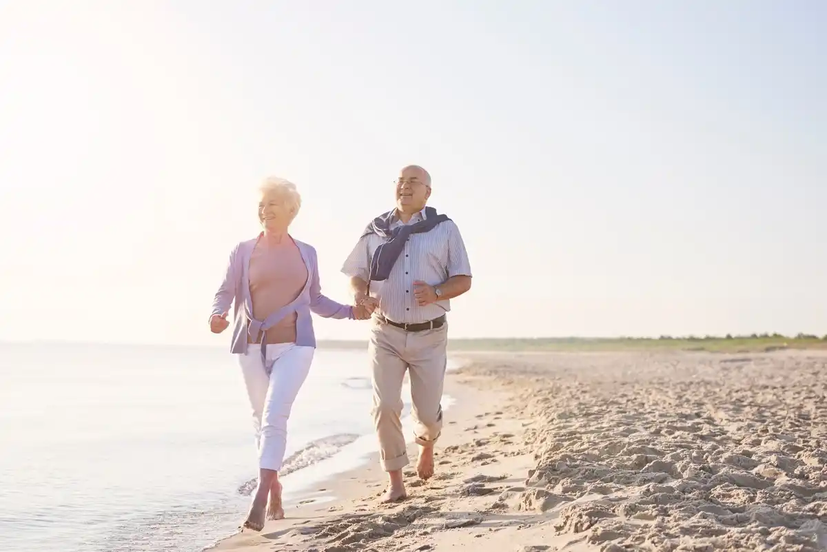 elderly couple biking sand dunes Netherlands