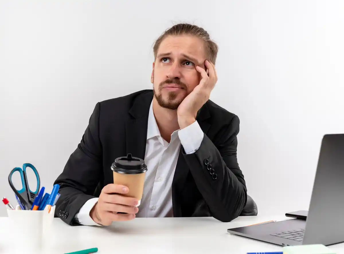 dutch office worker tired desk coffee