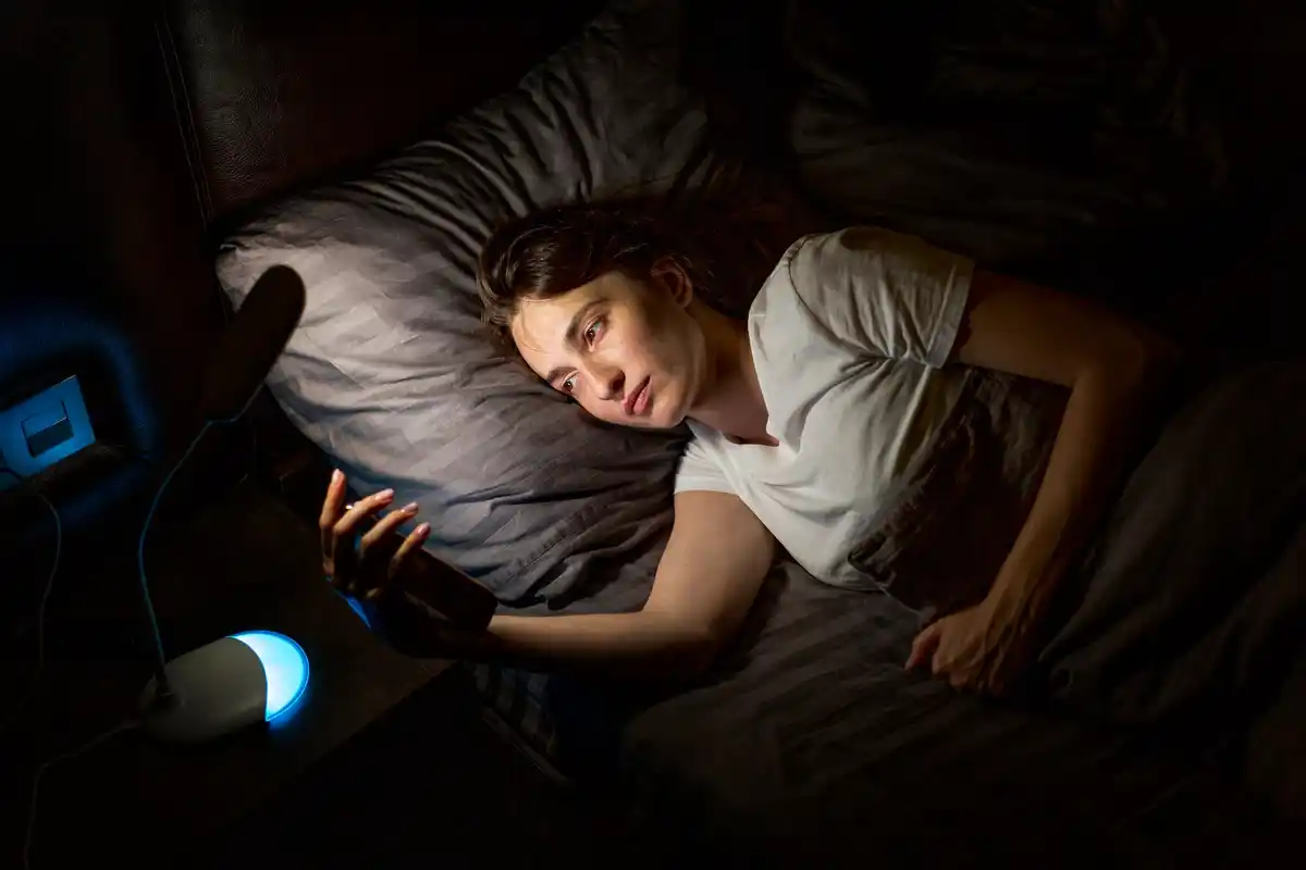 sleep scientist cuddling with robot in bed