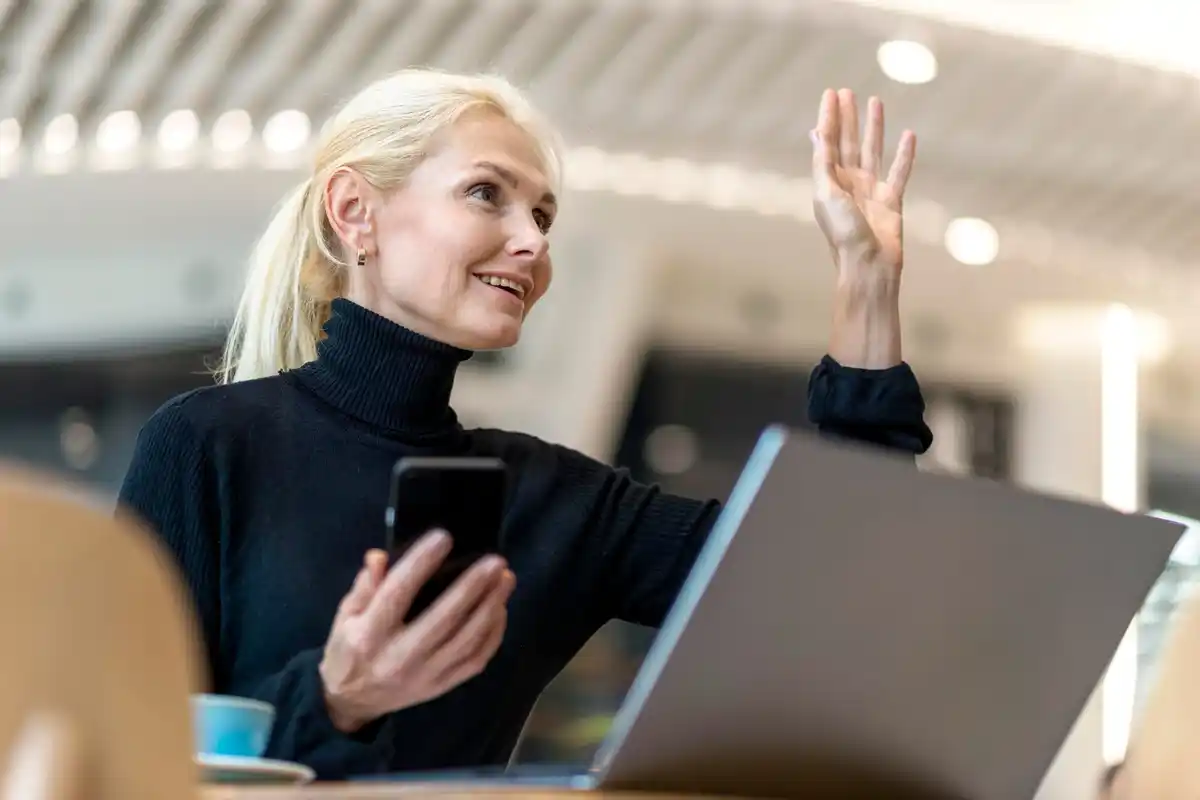 people using biometric authentication on mobile and laptop dutch office