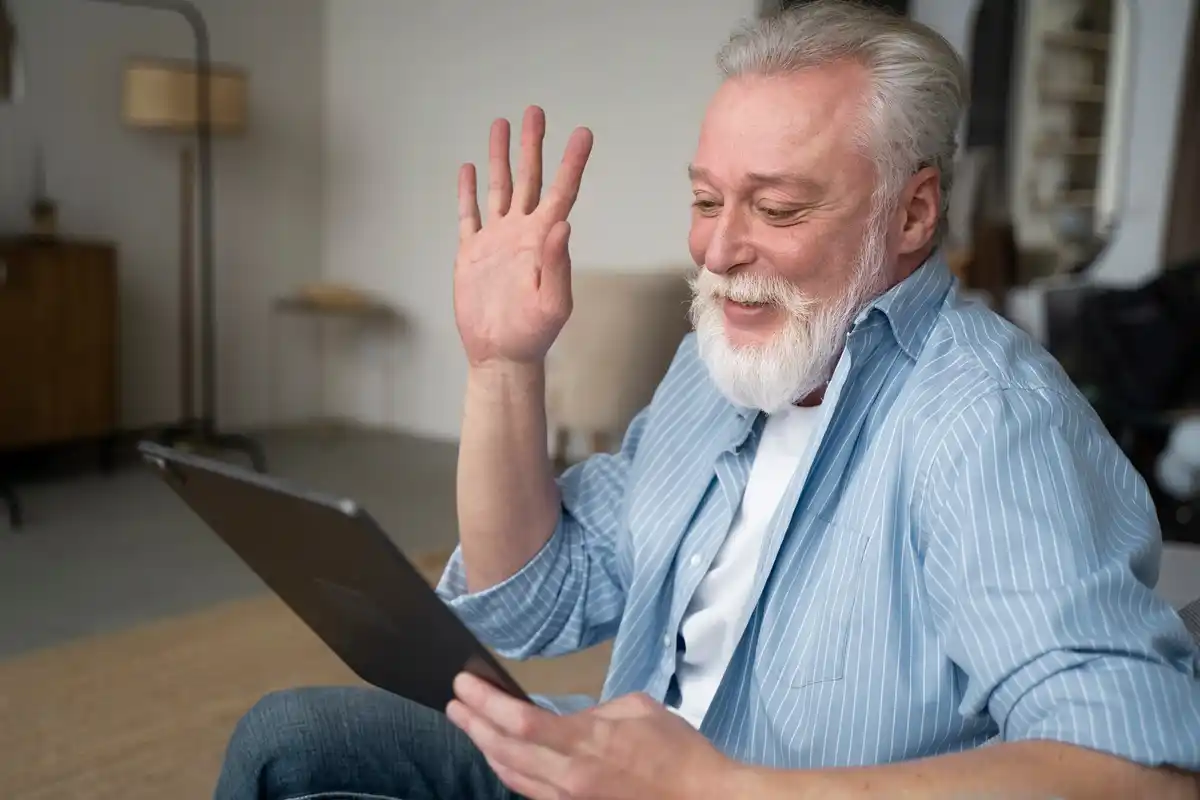 senior dutch man logging in to laptop using face recognition