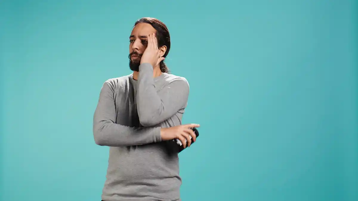 man holding back tears emotional struggle
