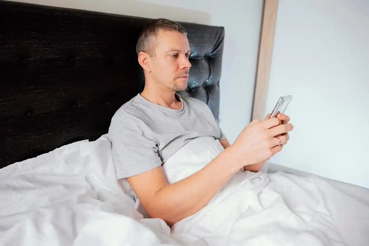 happy Dutch man waking up without phone in bed