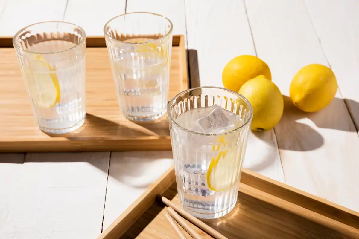 glass of lemon water close up, sunlight, Dutch kitchen table