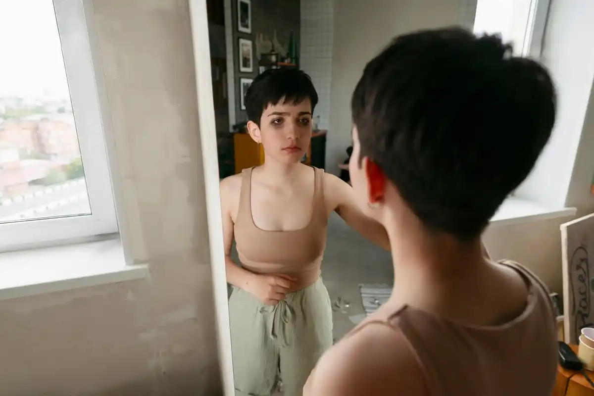 woman avoiding looking in mirror, casual home interior, Netherlands