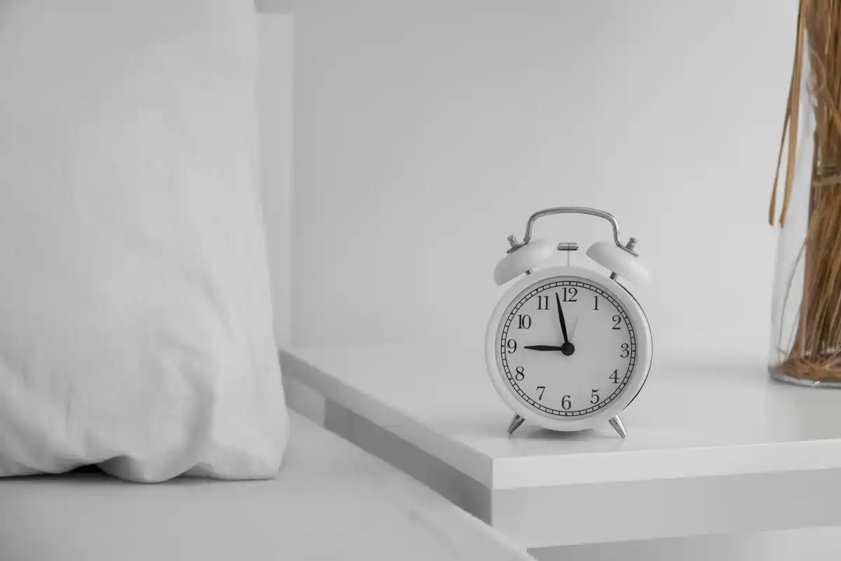 alarm clock and phone on nightstand Dutch bedroom