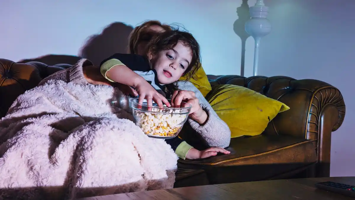 child watching space movie at home, family night, scared kid