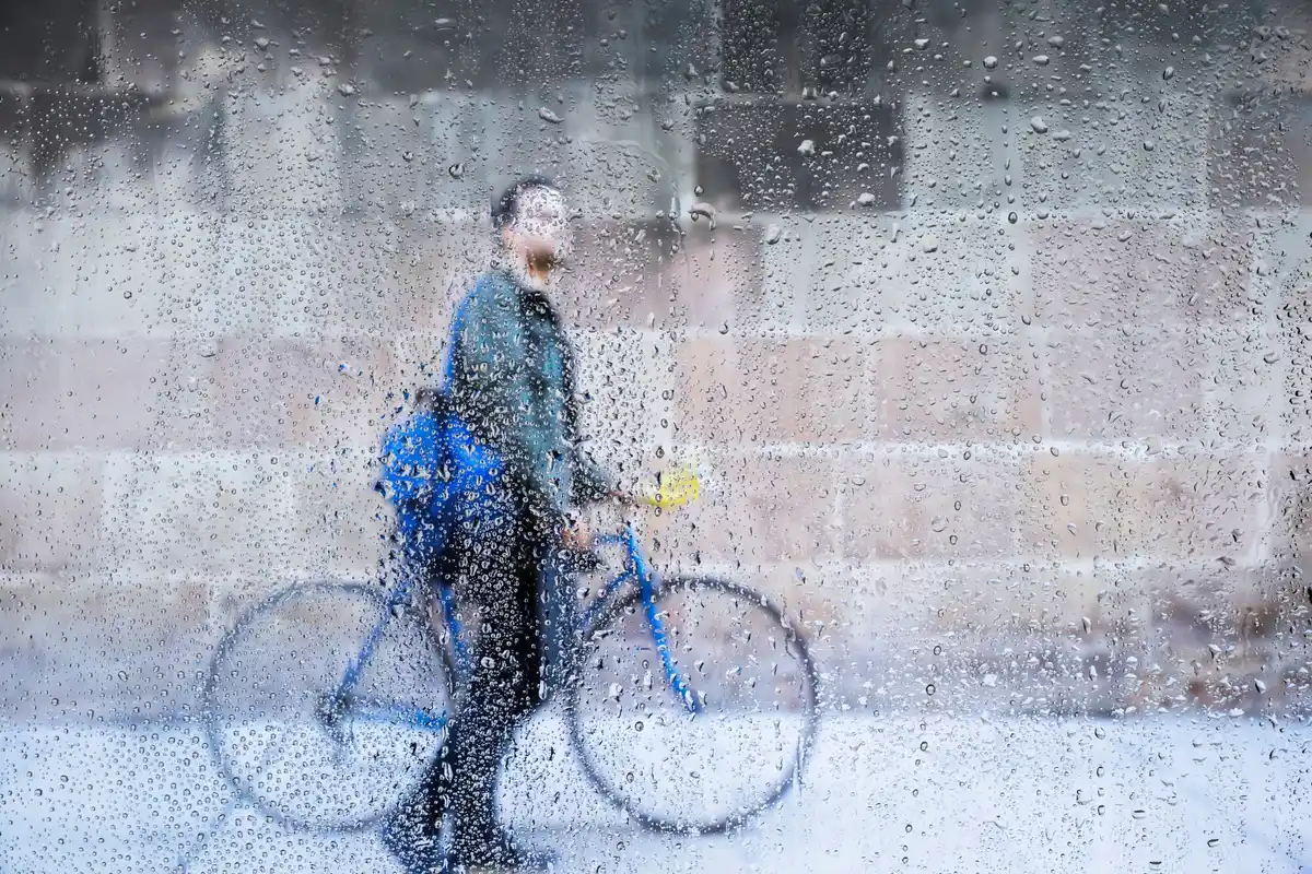 Dutch person cycling rain wind perseverance Amsterdam