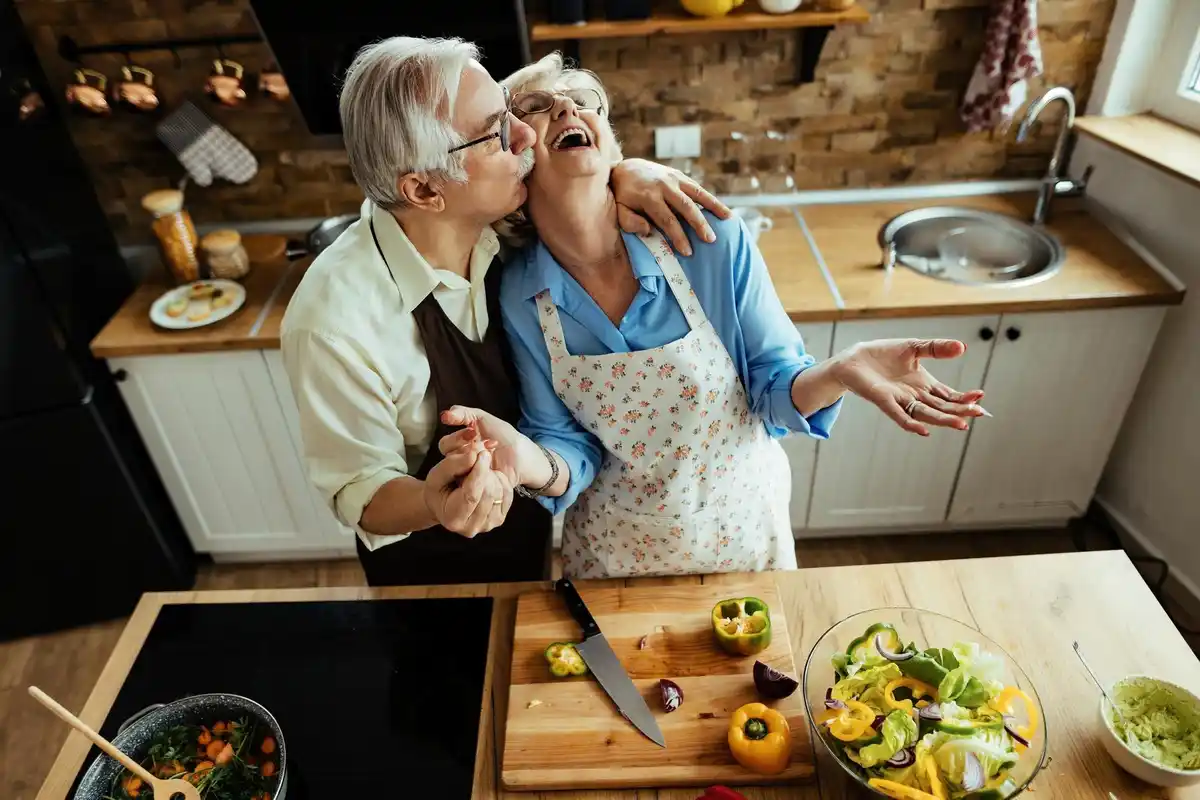 Dutch 50 plus couple cooking together historical meal home kitchen