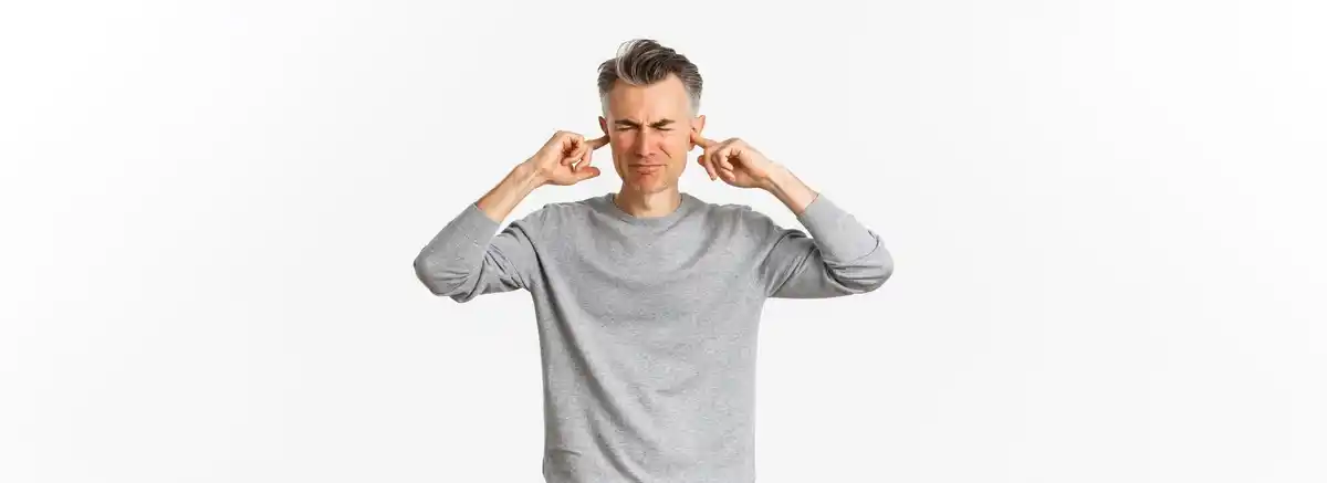 person covering ears silence isolation stress