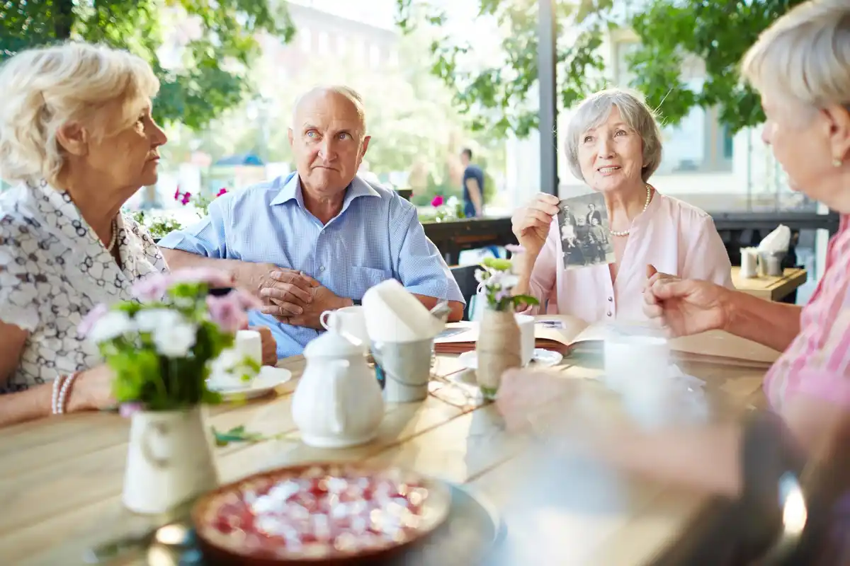 Dutch senior people small outdoor lunch in park spring