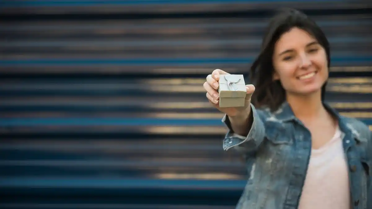 person holding rare Dutch coin in hand indoors