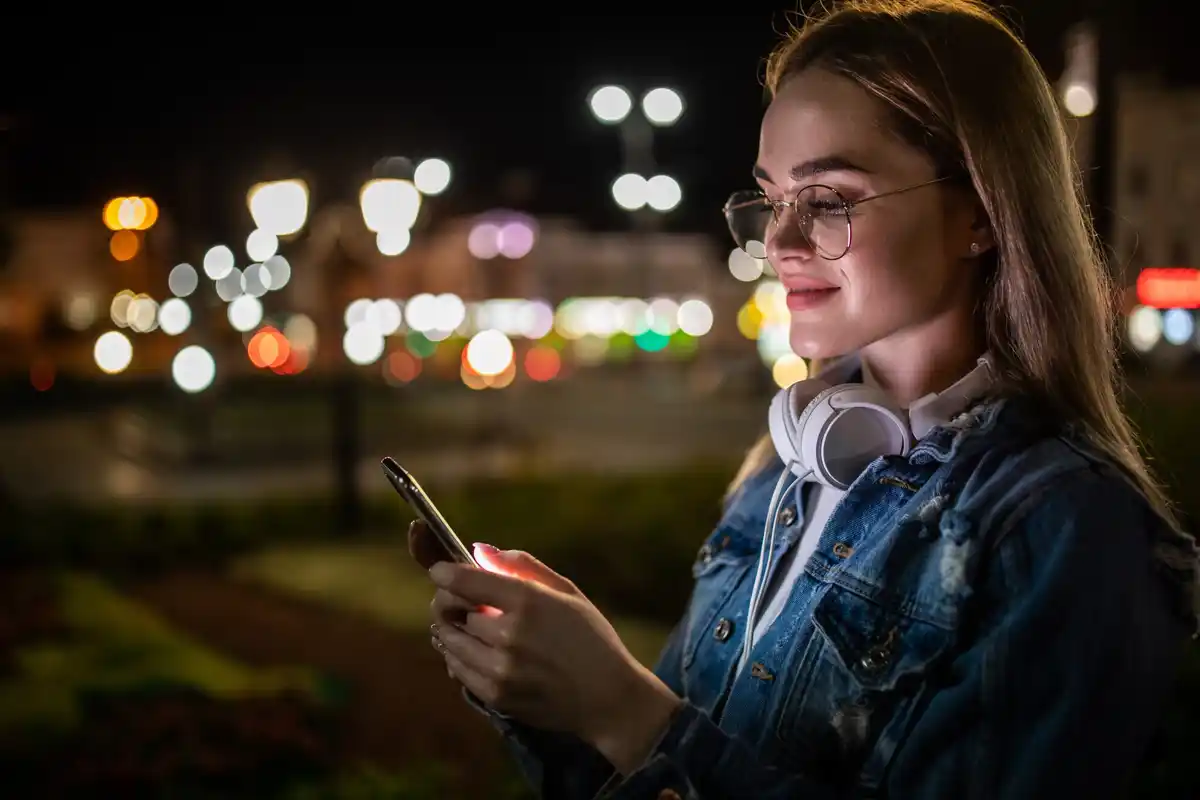dutch person using stargazing app at night urban skyline