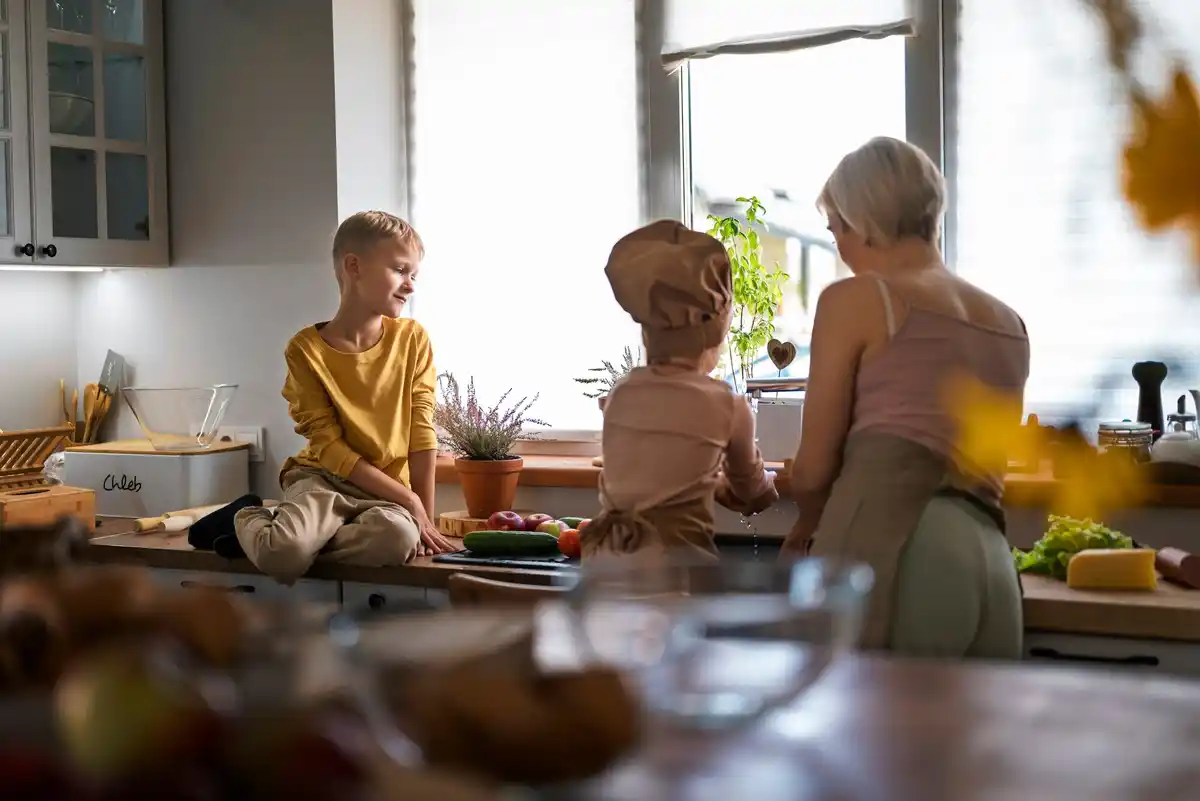 Family looking at old Dutch coins at kitchen table