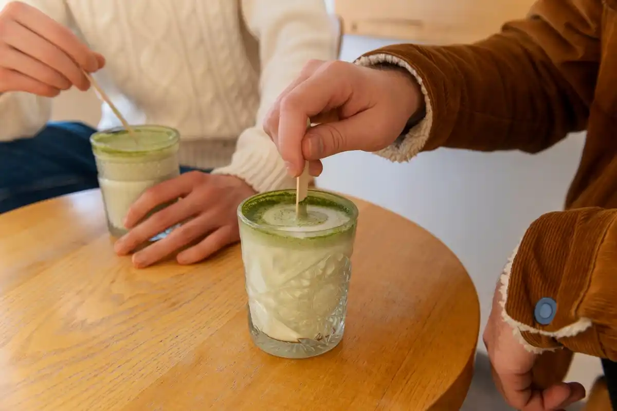 Preparing matcha tea at a Dutch breakfast table