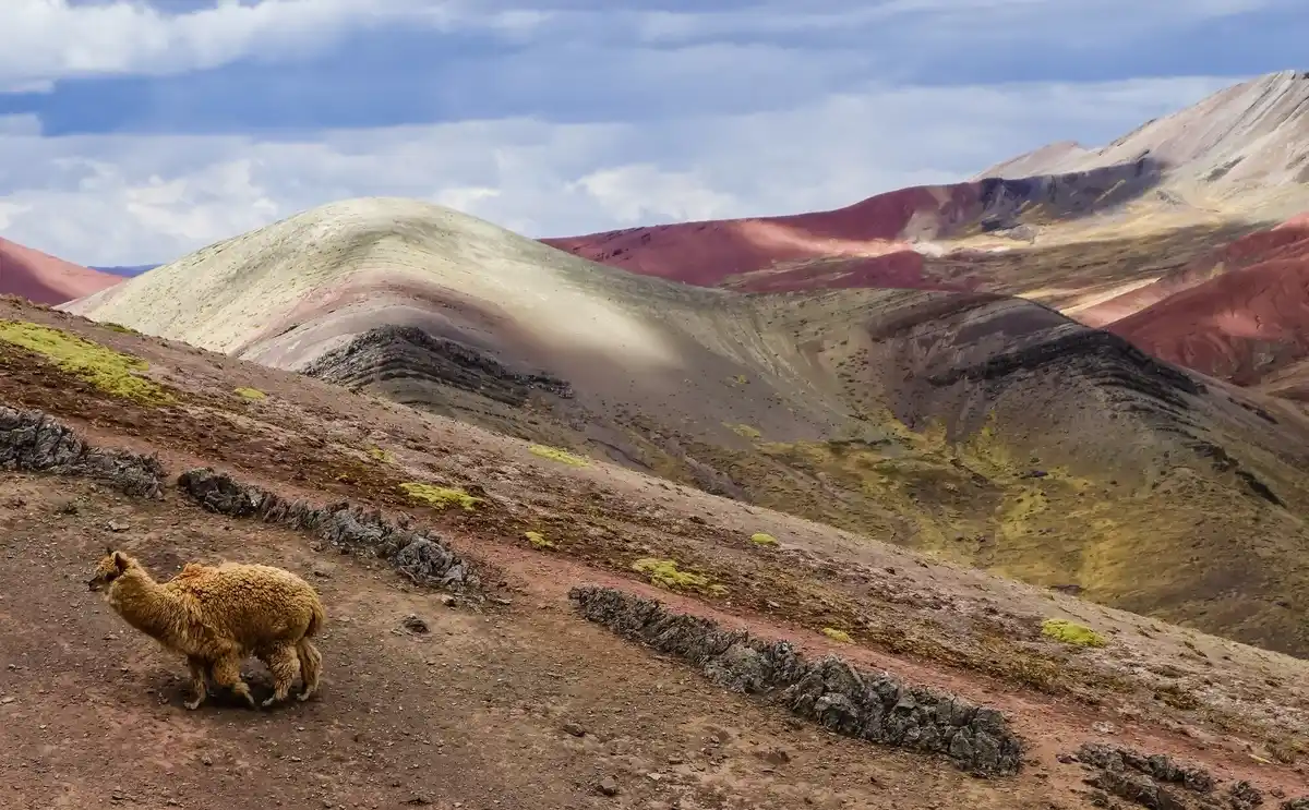 rainbow mountain peru sunrise wide shot dramatic sky