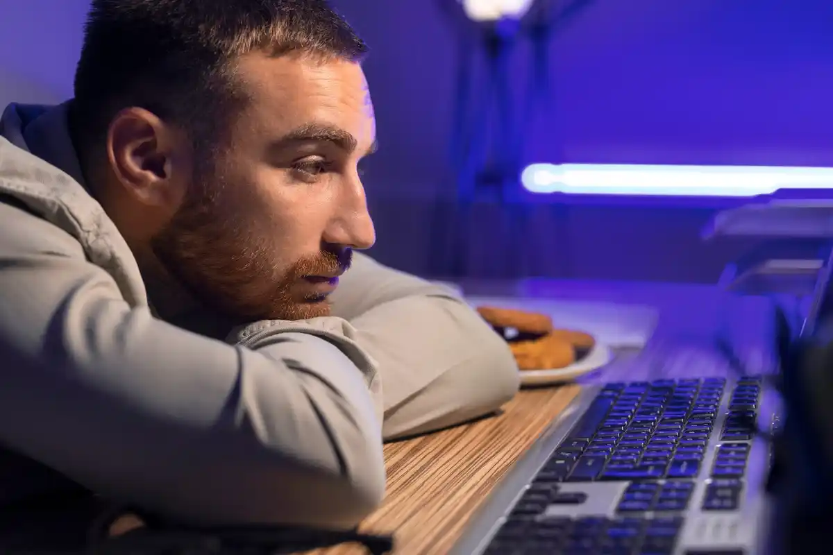 closed laptop sleeping programmer night office