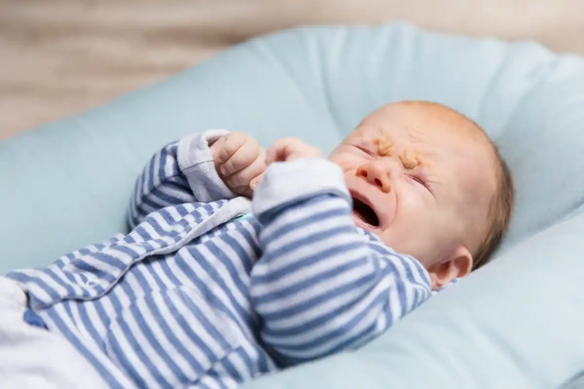 newborn baby crying looking right side