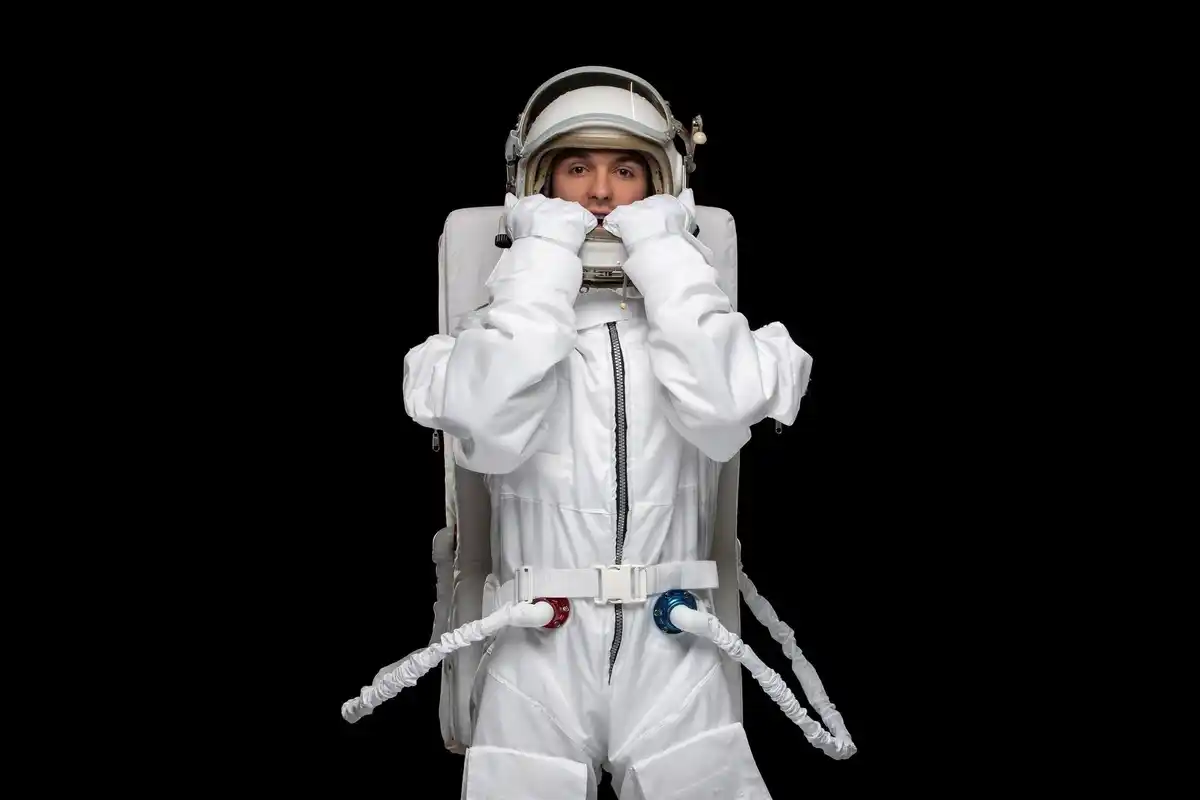 astronaut smelling spacesuit after spacewalk