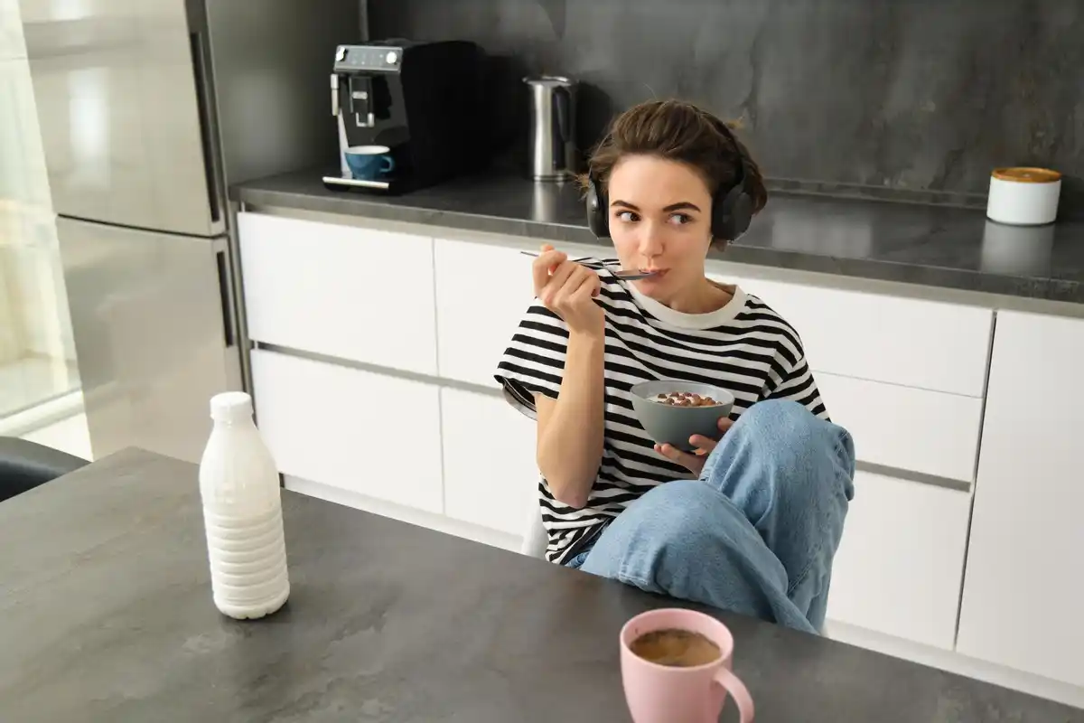 Dutch person thinking with coffee in hand at kitchen table