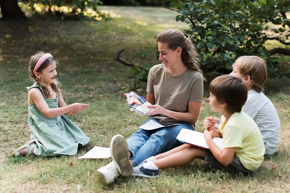 family sitting under tree sharing stories