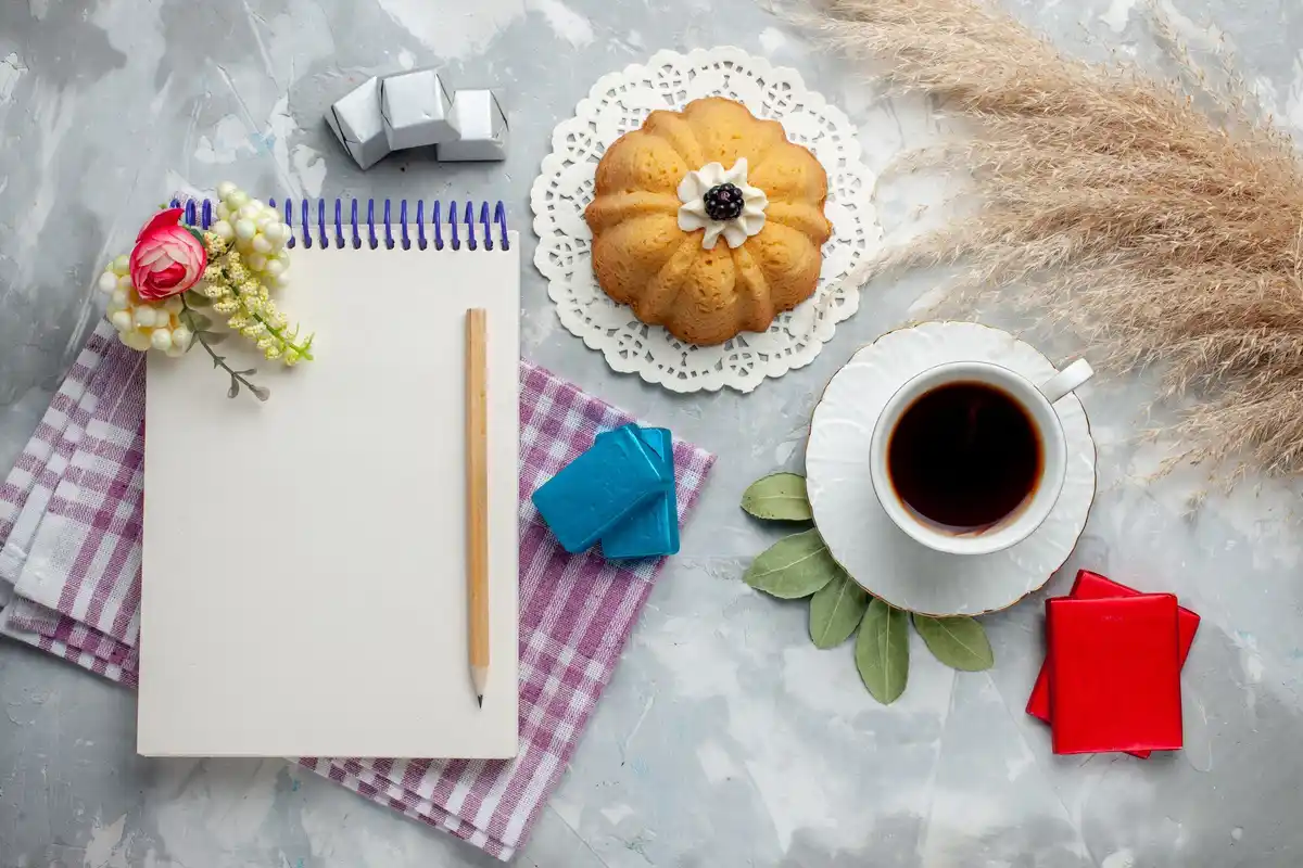Close up of a Dutch diary with handwritten pages and a coffee cup