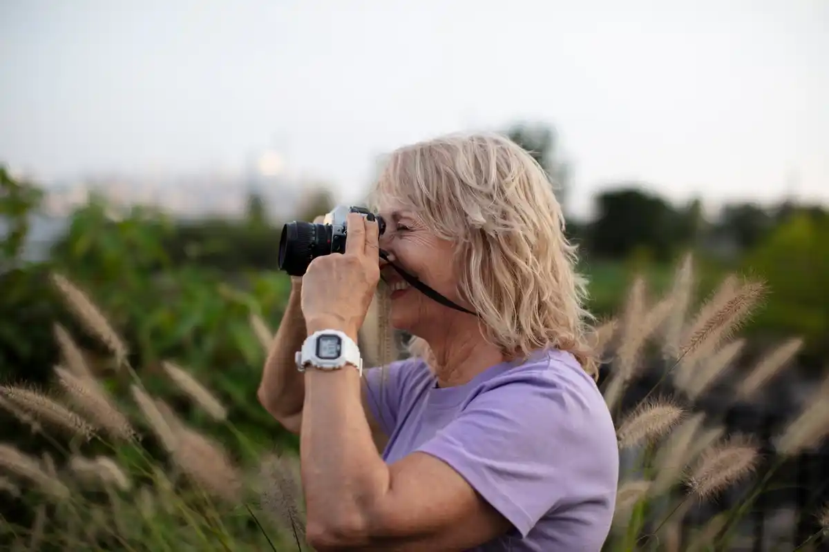 Elderly woman observing stars through telescope Netherlands observatory