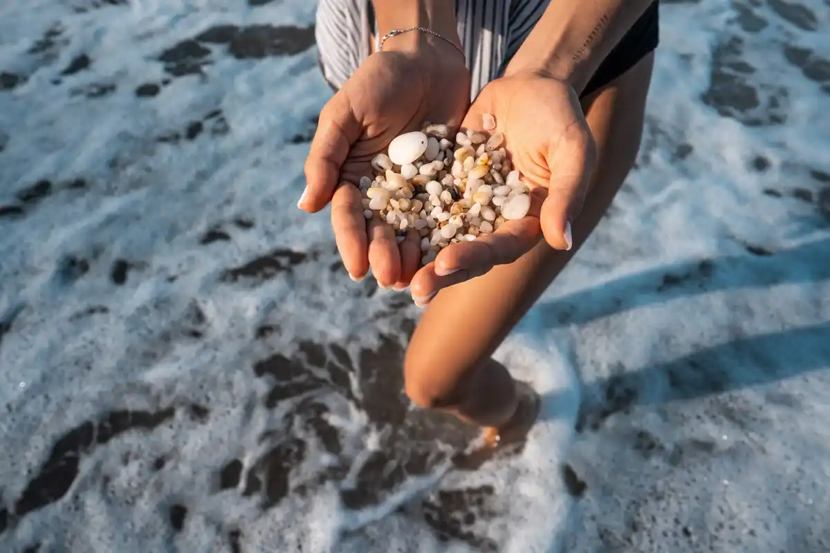 hand picking sea glass Zandvoort close up