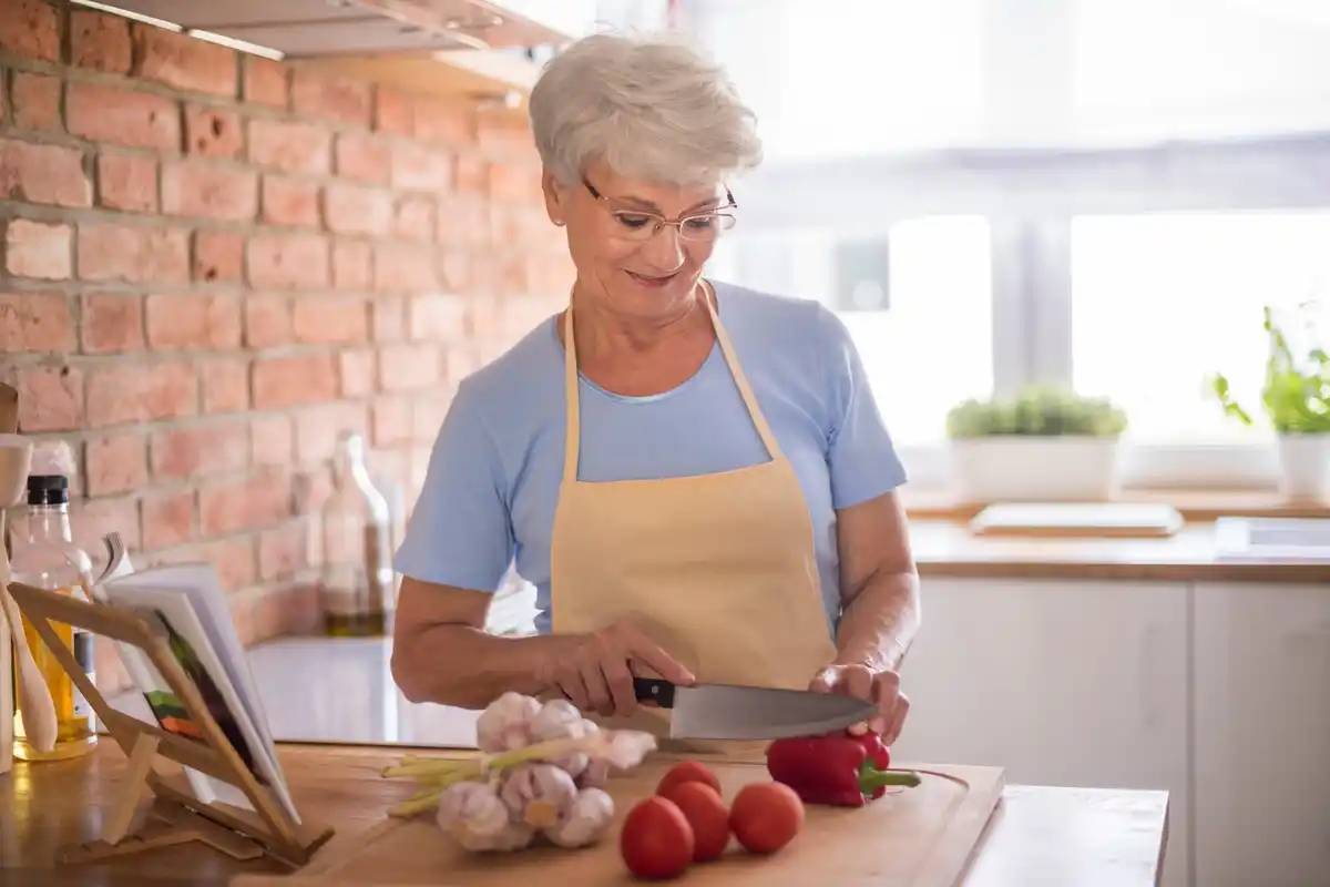Dutch grandmother fermenting cabbage in traditional kitchen